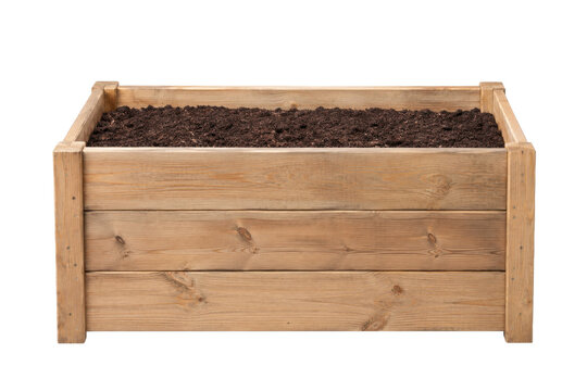 Rustic wooden raised garden bed filled with rich dark soil, ready for planting on a clean white background