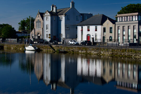 Reflections of Buildings and Sailboat along Claddagh Quay in Waters of Eglington Canal Galway County Galway Republic of Ireland