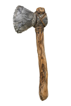 Ancient primitive stone axe with a rough gray blade and a rustic wooden handle, bound together with leather straps, isolated on a white background