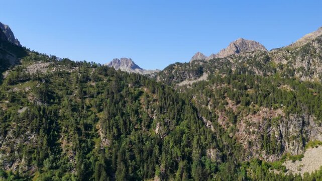 Aerial view of Cascada del Gerber waterfall plunging down granite cliffs near Aig&uuml;estortes National Park, Spanish Pyrenees
