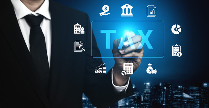 A businessman in a formal suit engages with digital tax symbols, representing the intersection of technology and finance in a modern office setting illuminated by blue light. Cyphers