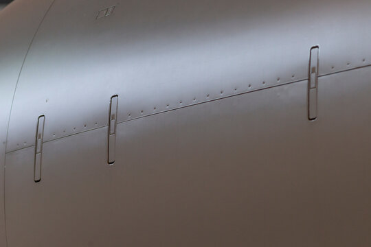 Close Gulfstream G fuselage seam showing rivets, panel joints and exterior skin texture, industrial finish with structural fasteners and engineering clarity