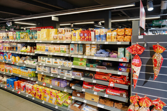 September 24, 2026, Amsterdam, Netherlands - Aisle filled with various packaged food products in a SPAR supermarket