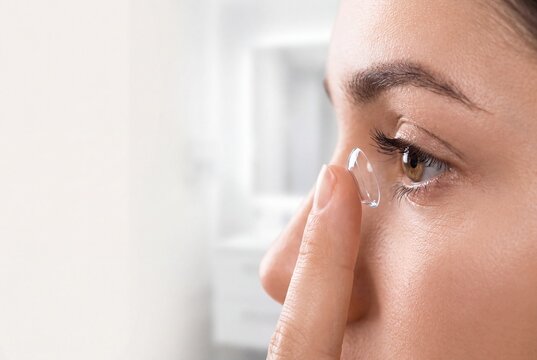 Young Woman Applying Contact Lens to Eye for Vision Correction