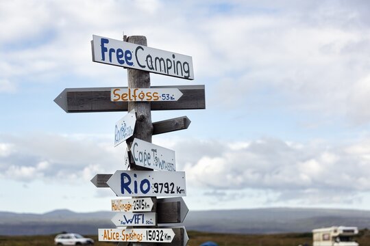 Signposts, signs, free camping, free WIFI, distance to Selfoss, Cape Town, Rio and Alice Springs, campsite in Selvogur, South Coast, Iceland