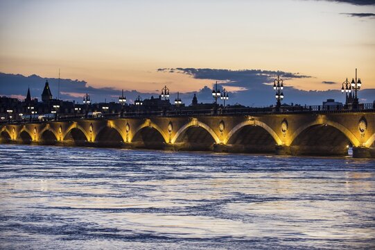 Pont de Pierre, historical bridge over the Garonne river at dusk, Bordeaux, France