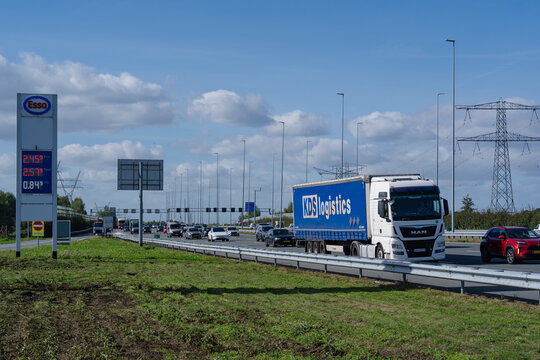 September 24, 2026, Amsterdam, Netherlands - Traffic on a highway with an Esso gas price sign and a KDS logistics truck