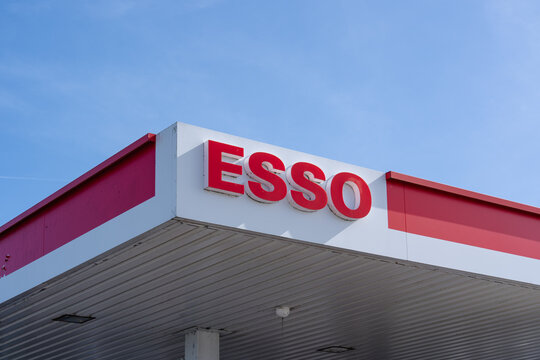 September 24, 2026, Amsterdam, Netherlands - Esso gas station sign and canopy against a blue sky