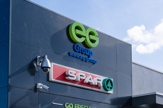 September 24, 2026, Amsterdam, Netherlands - Exterior view of a building featuring EG Group and SPAR logos with security cameras