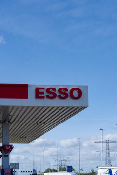 September 24, 2026, Amsterdam, Netherlands - ESSO gas station sign and canopy under a blue sky