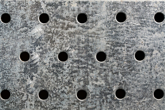 Perforated galvanized metal sheet texture with holes. Industrial perforated steel plate. Background of zinc coated iron grid sheet with circular holes for construction, hardware and workshop concept