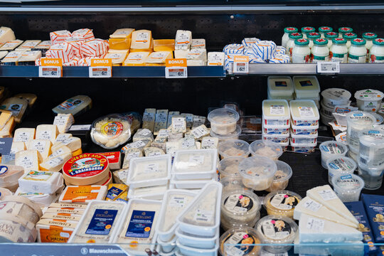 September 26, 2026, Amsterdam, Netherlands - Various cheeses and dairy products displayed in a refrigerated section at Albert Heijn XL supermarket