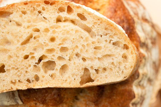 Porous bread crumb fills frame in close-up, showing airy structure and warm wheat color. Baking content can highlight sourdough texture, freshness, fermentation, artisan quality and food detail.