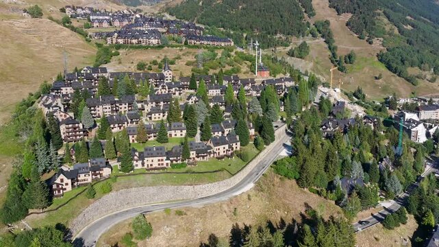 Aerial view of luxury chalets and slate-roof villas in Baqueira village during summer, Val d'Aran, Spanish Pyrenees, Spain