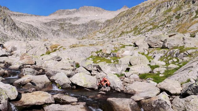 Aerial view of hikers trekking up Vall de Molieres towards Molieres peak with view of Aneto glacier, Pyrenees, Spain