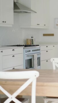 Vertical video: Panning shot from left, camera revealing pale blue range and jars, showing styling