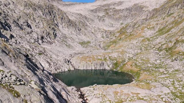 Aerial view of hikers trekking up Vall de Molieres towards Molieres peak with view of Aneto glacier, Pyrenees, Spain