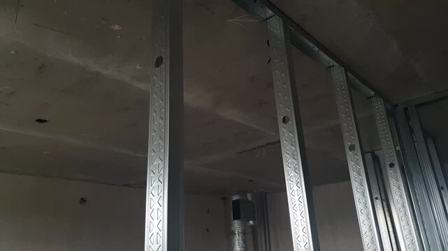 Construction of a framework for drywall installation and the creation of walls and partitions in an apartment. Construction of a framework using galvanized metal profiles.
