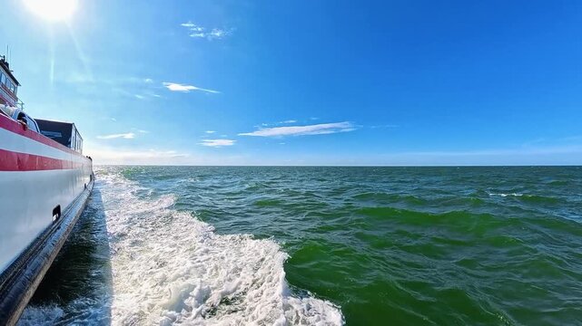 4K onboard video captures waves beneath scattered clouds during a North Carolina crossing.