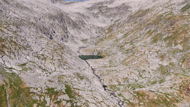 Aerial view of hikers trekking up Vall de Molieres towards Molieres peak with Aneto glacier view in Spanish Pyrenees