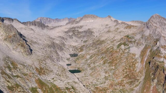 Aerial view of hikers trekking up Vall de Molieres towards Molieres peak with Aneto glacier view in Spanish Pyrenees