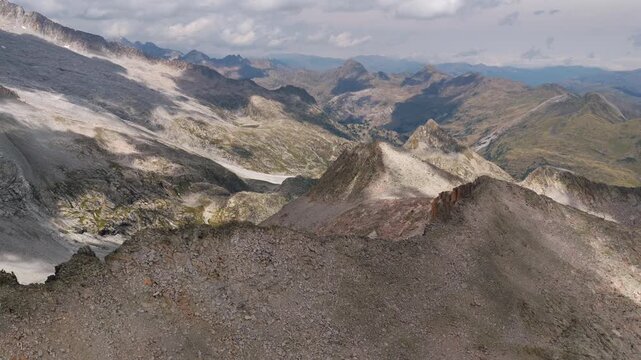 Aerial view of shrinking Monte Perdido glacier and exposed rock face due to climate change, Pyrenees, Spain