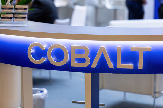 Amsterdam, Netherlands - September 11, 2026: Cobalt booth sign with illuminated blue and gold lettering at IBC media and technology exhibition