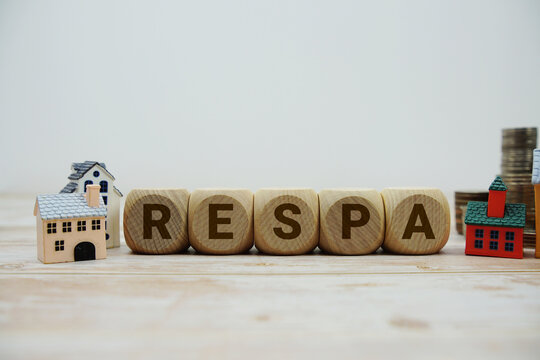 RESPA (Real Estate Settlement Procedures Act) with magnifying glass and house model