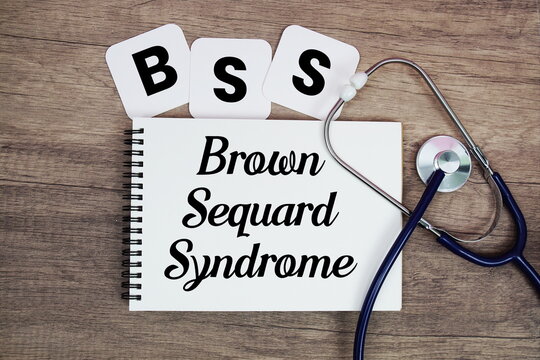 BSS Brown Sequard Syndrome text written on notepad with stethoscope on wooden background