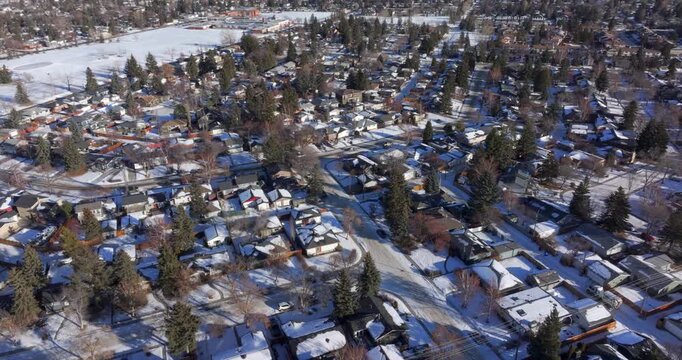 Aerial view of a residential neighborhood blanketed in snow on a winter day in Calgary, Alberta, Canada.