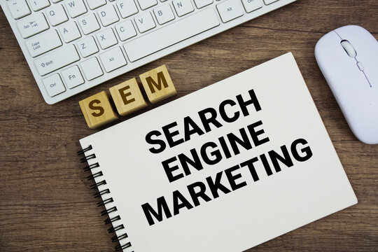 SEM Search Engine Marketing message with keyboard and optical mouse on wooden background