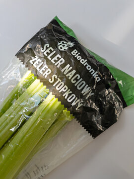 WARSAW, POLAND - MAY 1, 2026: Close up of fresh green celery stalks in plastic from Biedronka store (Seler Naciowy). Concept of vegetable retail design, fresh produce, and grocery goods.