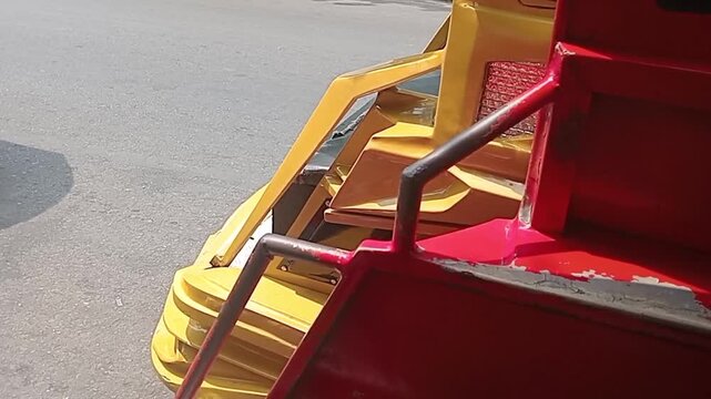 A row of bentor motorized rickshaws waiting for school students to go home in Kotamobagu
