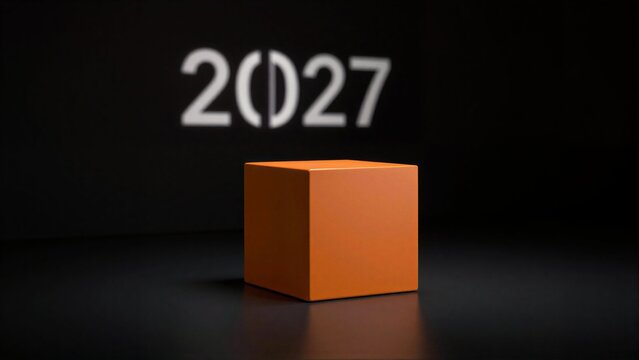 Orange cube on dark surface, glowing 2027 projected behind it.