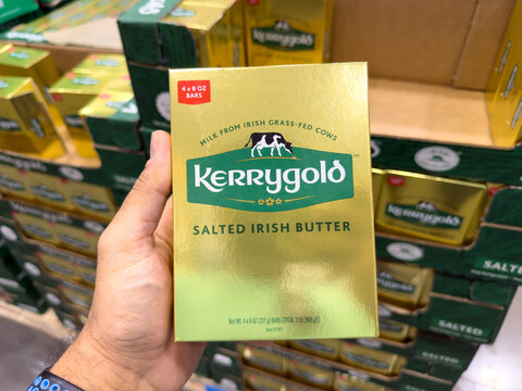 Prosper, Texas, USA - September 16th, 2026: Person holding Kerrygold Salted Irish Butter gold box inside Costco store