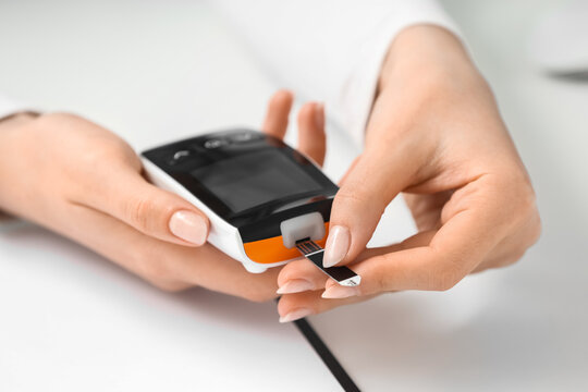Diabetes management and blood glucose monitoring, person using a digital glucometer to check sugar levels for health diagnostics and medical care