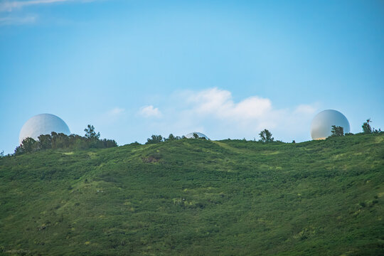 Some buildings behind a mountain