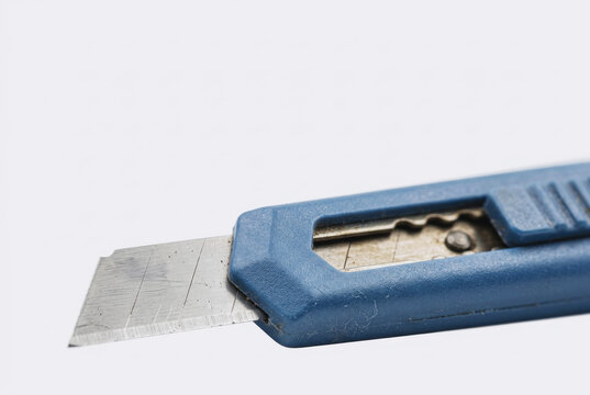 Blue utility knife with exposed blade on white background