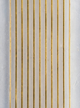 Gold micro thread channel texture on pale metallic surface, creating refined linear industrial background with subtle variation