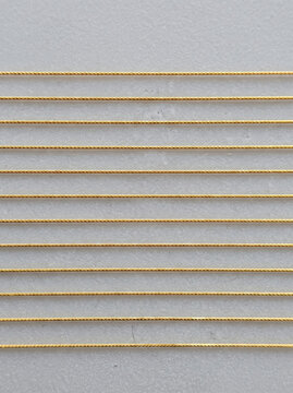Gold micro thread silicone surface horizontal line metallic texture parallel row Gold micro thread silicone surface with