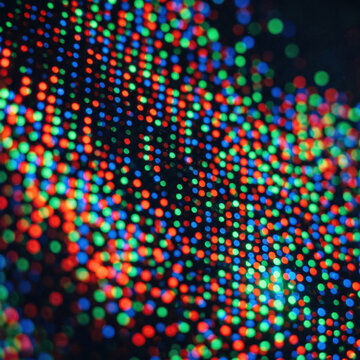 Colorful subpixel lights create glowing abstract display with vibrant circles and dark depth for dynamic background