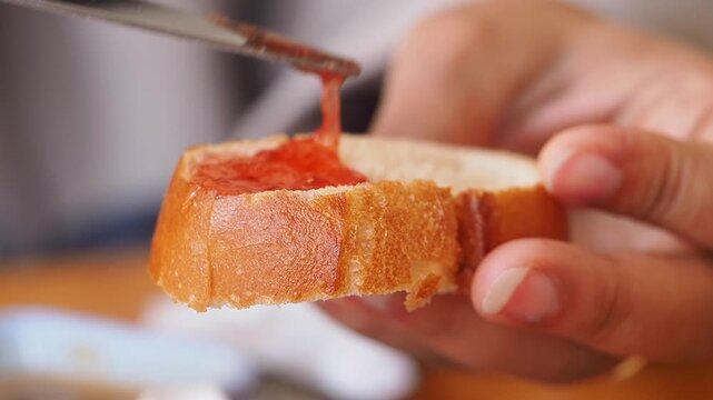 Making bread topped with delicious jam in a cozy kitchen