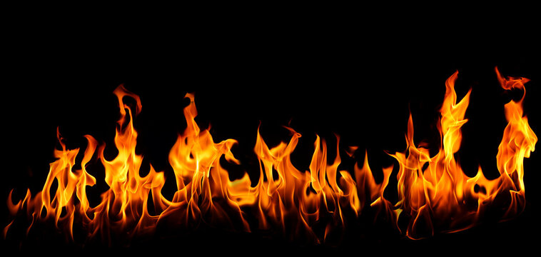 fire flames rise against a black background, creating a fiery effect with glowing yellow highlights, dramatic heat, and dark negative space for cinematic designs, posters, and overlays.