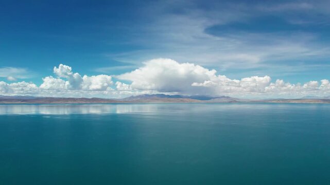 Drone view Lake Manasarovar in Xizang Ali&zwnj;, Peaceful snow mountains, white clouds and reflections on blue lake&zwnj;&zwnj; in western Himalayas, Xizang, China. 4k real time footage travel concept b roll shot.