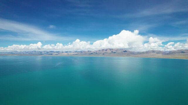 Drone view Lake Manasarovar in Xizang Ali&zwnj;, Peaceful snow mountains, white clouds and reflections on blue lake&zwnj;&zwnj; in western Himalayas, Xizang, China. 4k real time footage travel concept b roll shot.