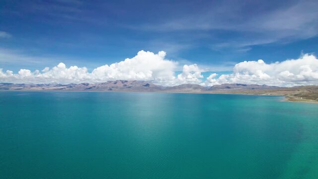 Drone view Lake Manasarovar in Xizang Ali&zwnj;, Peaceful snow mountains, white clouds and reflections on blue lake&zwnj;&zwnj; in western Himalayas, Xizang, China. 4k real time footage travel concept b roll shot.