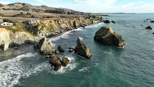 Aerial view of dramatic offshore sea stacks and rugged coastal cliffs near Duncan's Point, California, with Pacific Ocean waves surrounding the rocky formations along the Northern California coast.