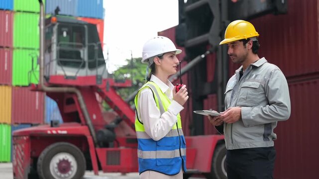 Port logistics team conducts a field inspection near stacked shipping containers and a reach stacker, reviewing digital data for safe and efficient cargo operations.