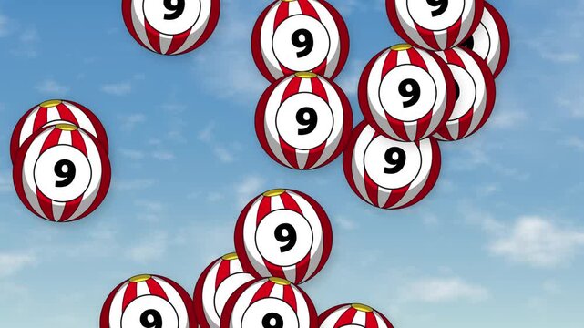 Group of Red and White Striped Number Nine Balls Bursting Over Sky