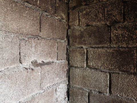 Close-up background texture of dirty weathered concrete cinder block wall corner